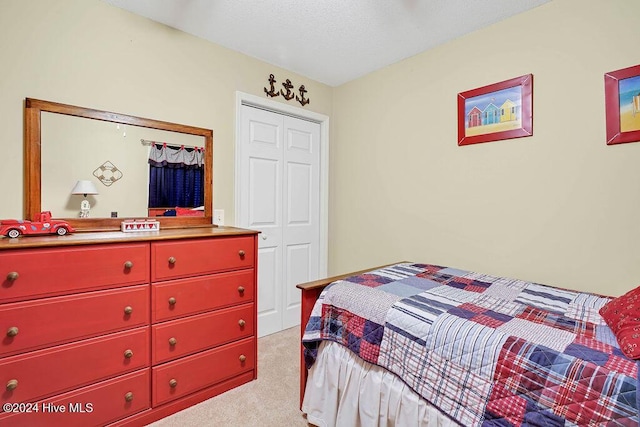 bedroom featuring a closet and light colored carpet