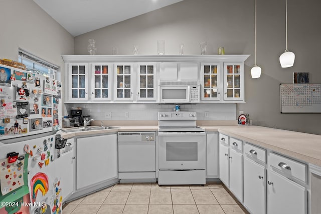 kitchen with sink, vaulted ceiling, decorative light fixtures, white appliances, and white cabinets