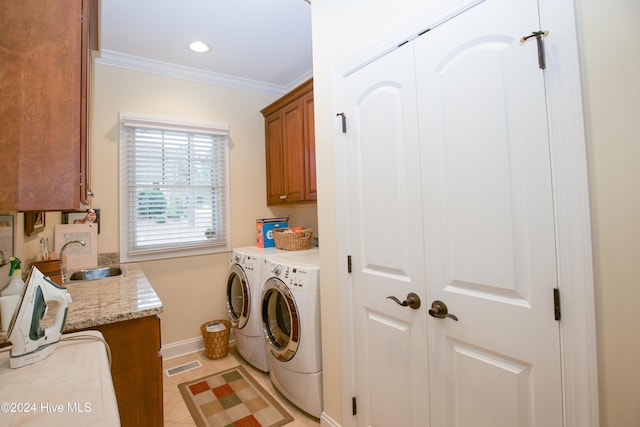 laundry area featuring cabinets, sink, separate washer and dryer, light tile patterned floors, and ornamental molding