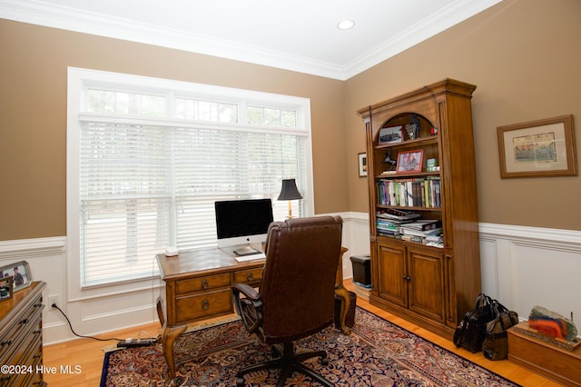 office area featuring plenty of natural light, light wood-type flooring, and crown molding