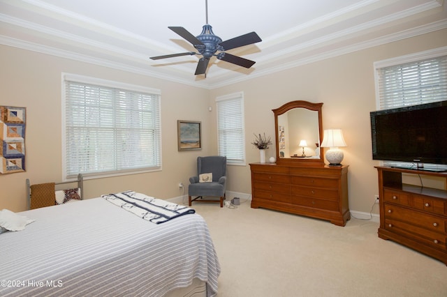 bedroom featuring ceiling fan, crown molding, light carpet, and multiple windows