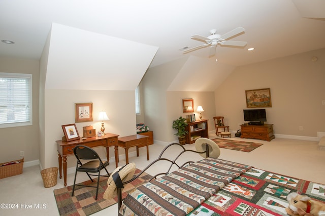 interior space featuring ceiling fan, light colored carpet, and lofted ceiling