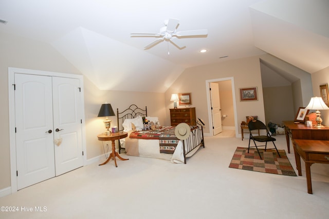 carpeted bedroom featuring ceiling fan, a closet, and lofted ceiling