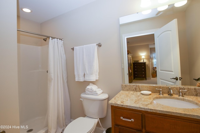 bathroom with vanity, toilet, and walk in shower