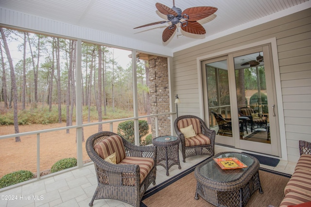 sunroom with ceiling fan and plenty of natural light