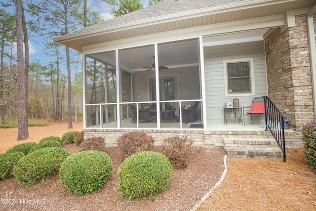 rear view of property featuring a sunroom