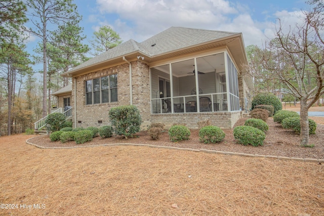 view of home's exterior with a sunroom