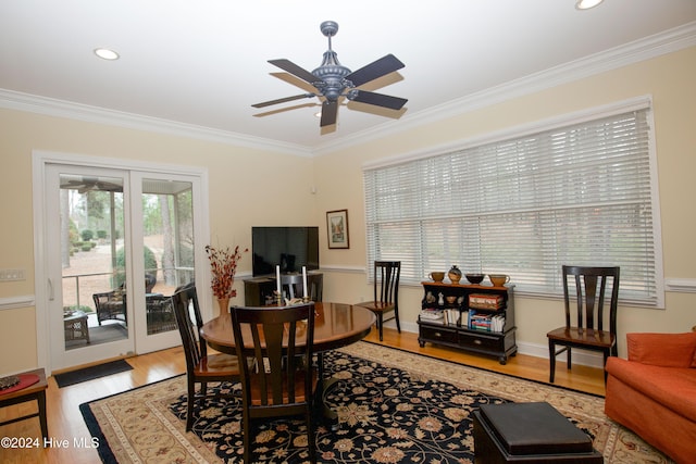 dining room with crown molding, ceiling fan, and light wood-type flooring