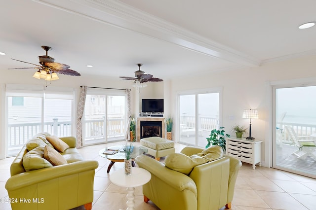 tiled living room with beamed ceiling, ceiling fan, and crown molding