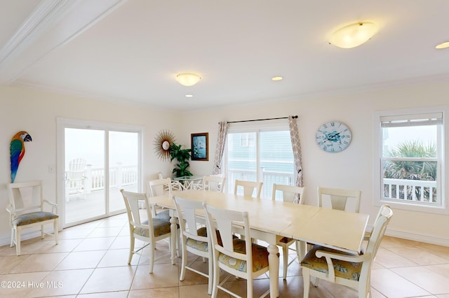 dining room featuring ornamental molding, light tile patterned floors, and a healthy amount of sunlight