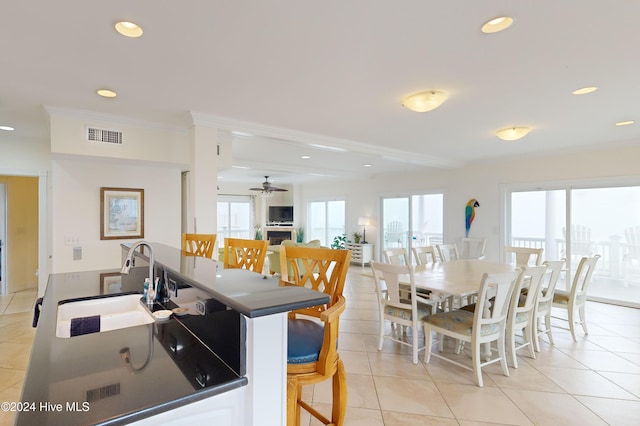 kitchen with ceiling fan, a healthy amount of sunlight, light tile patterned floors, and sink