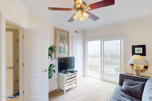 living room with light colored carpet, ceiling fan, and crown molding