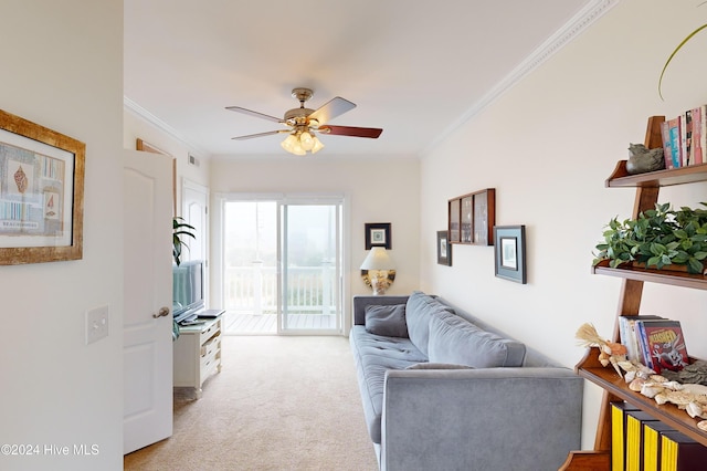 living room featuring light carpet, ceiling fan, and ornamental molding