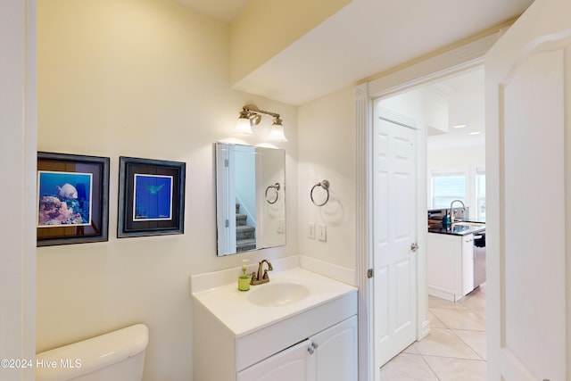 bathroom featuring tile patterned floors, vanity, and toilet