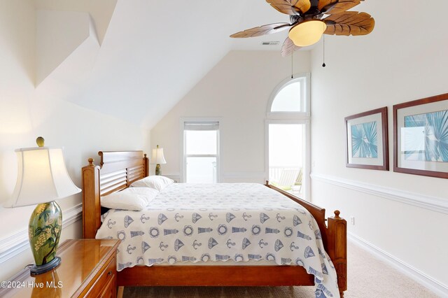 carpeted bedroom featuring multiple windows, lofted ceiling, and ceiling fan