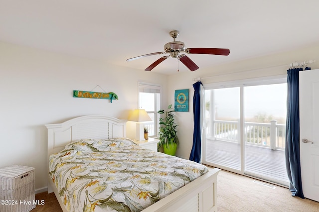 carpeted bedroom featuring access to exterior and ceiling fan