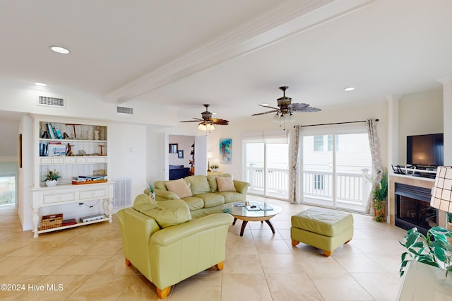 tiled living room with beam ceiling, ceiling fan, and crown molding