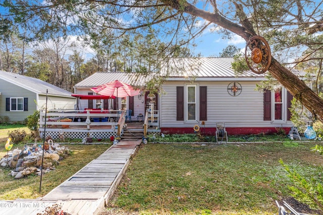 view of front of property featuring a front yard and a wooden deck