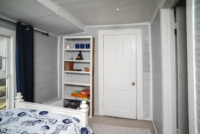 carpeted bedroom with ornamental molding