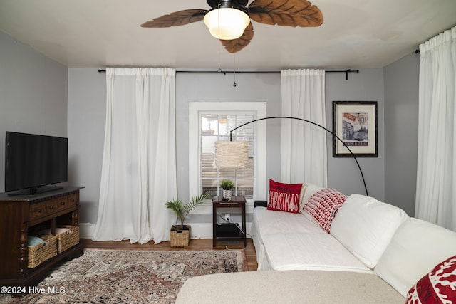 living area featuring ceiling fan and wood finished floors