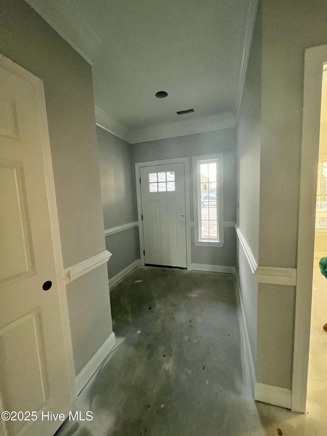 entrance foyer with concrete flooring and ornamental molding