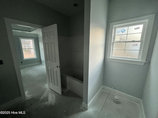 full bathroom with baseboards and a bath