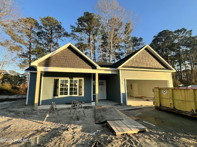 view of front of property featuring a porch and an attached garage