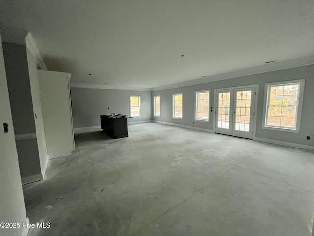 unfurnished living room featuring baseboards, french doors, ornamental molding, and unfinished concrete floors