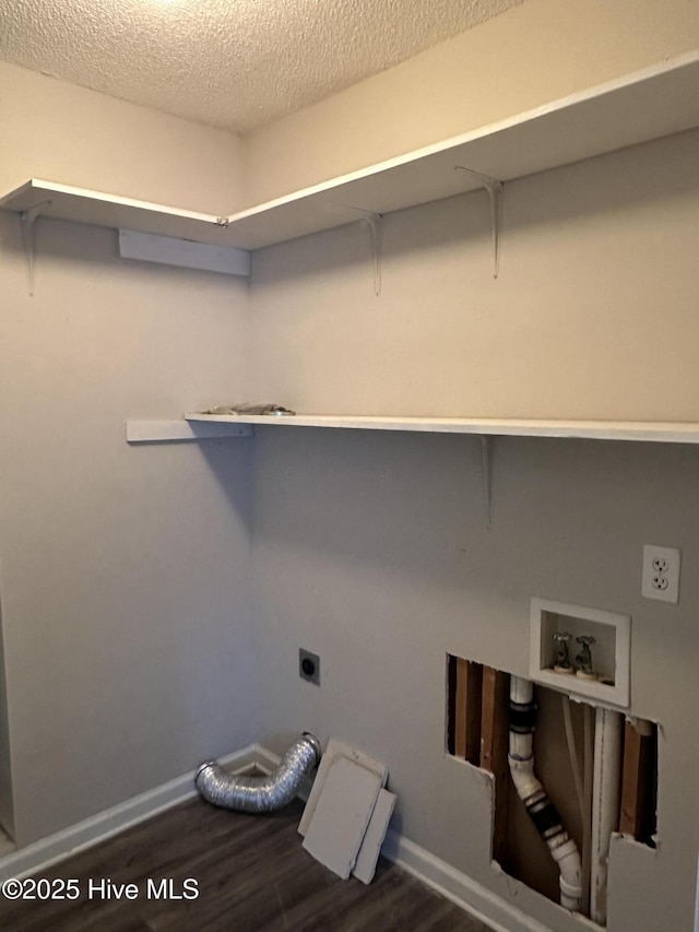 clothes washing area with a textured ceiling, electric dryer hookup, dark wood-type flooring, and hookup for a washing machine