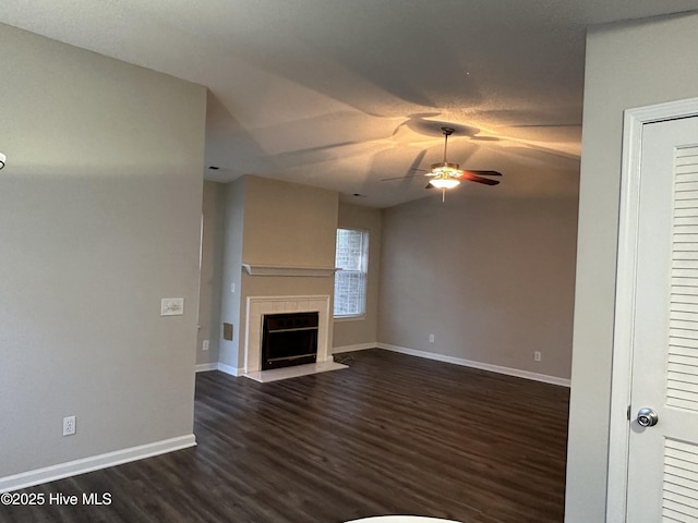 unfurnished living room with dark hardwood / wood-style flooring, ceiling fan, and lofted ceiling