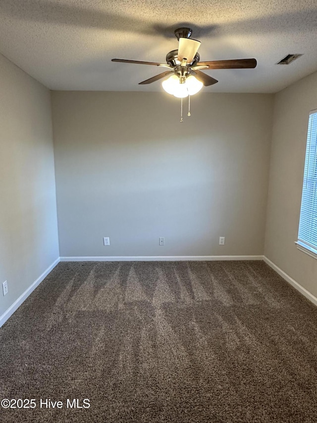 carpeted empty room with a textured ceiling and ceiling fan