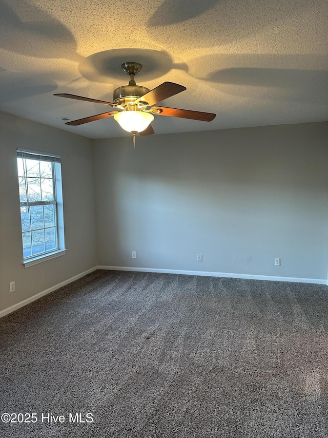 carpeted spare room with ceiling fan and a textured ceiling