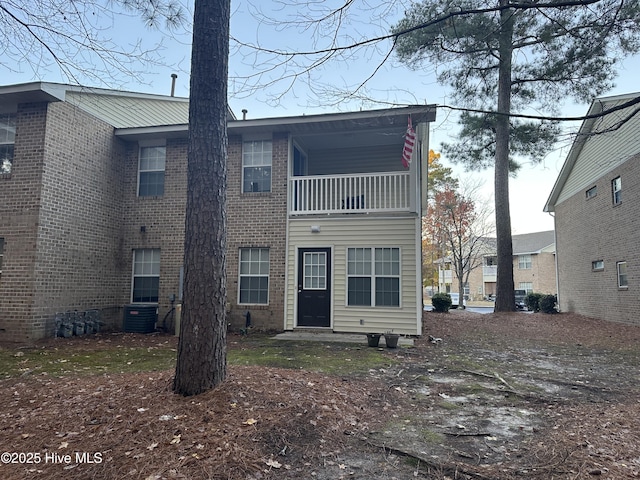 rear view of house with a balcony and central AC unit