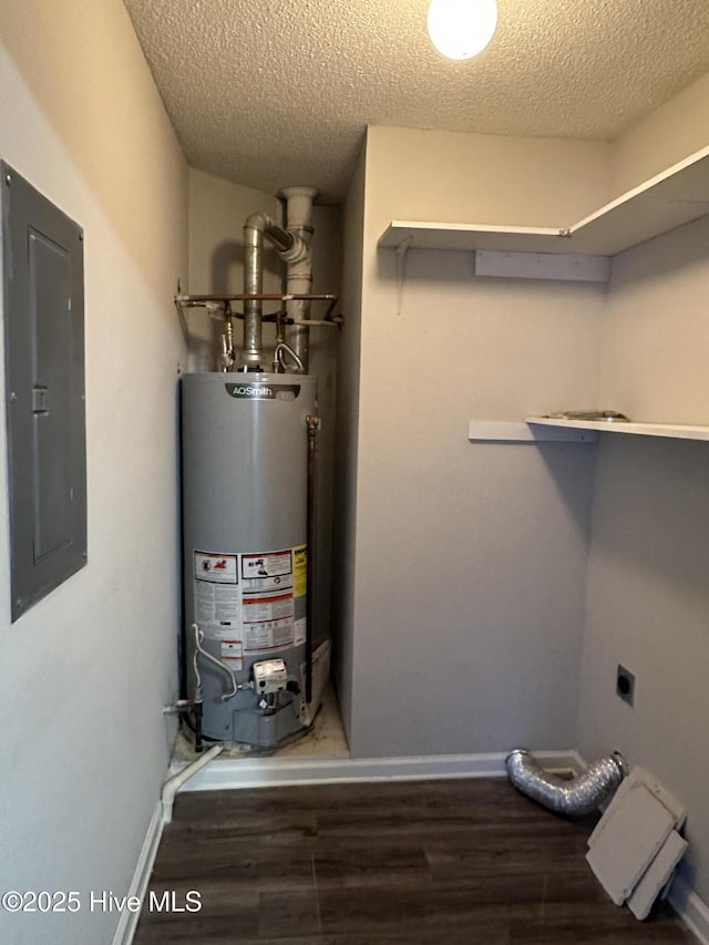 utility room featuring electric panel and water heater