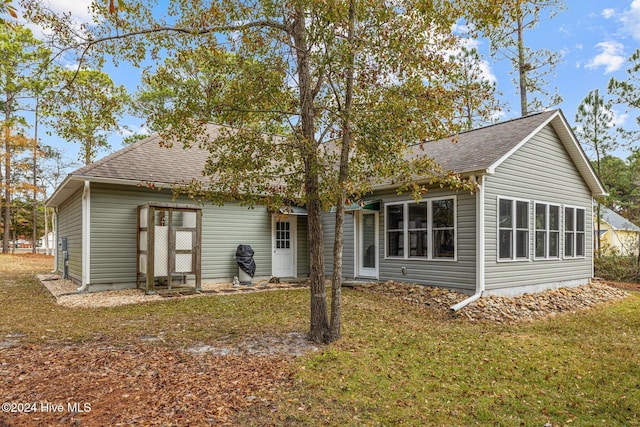 rear view of house with a lawn