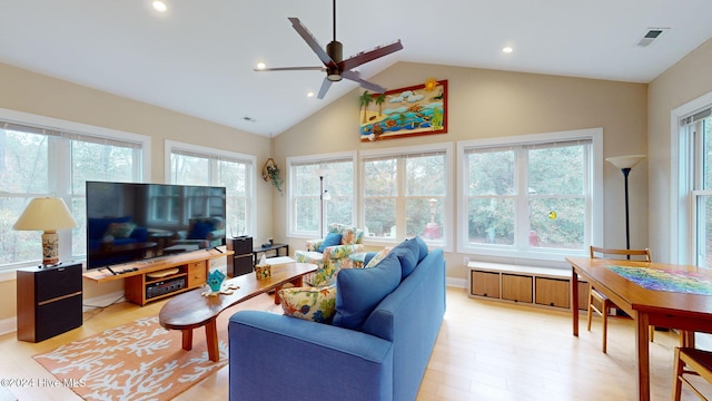 living room with high vaulted ceiling, light hardwood / wood-style flooring, plenty of natural light, and ceiling fan