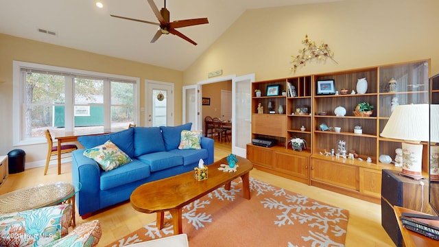 living room with ceiling fan, high vaulted ceiling, and light wood-type flooring