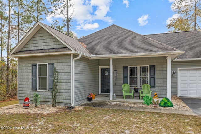 view of front of home with a porch and a garage