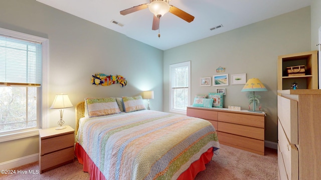 carpeted bedroom with ceiling fan and vaulted ceiling