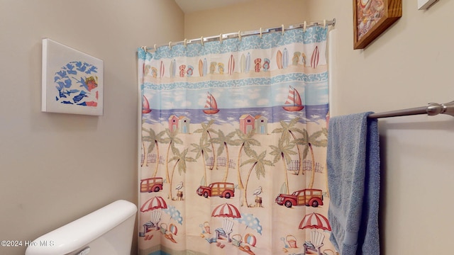 bathroom with toilet and curtained shower