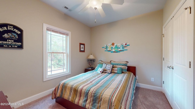 carpeted bedroom with a closet and ceiling fan