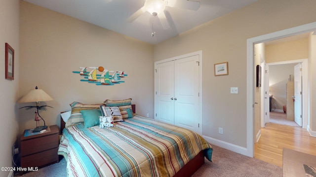 bedroom with hardwood / wood-style floors, a closet, and ceiling fan