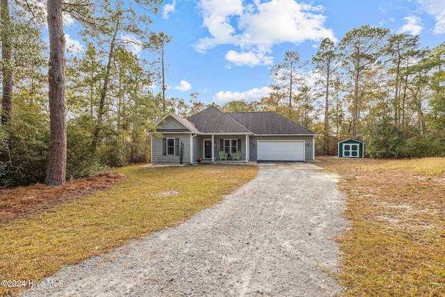 ranch-style house featuring covered porch, a front lawn, and a storage unit