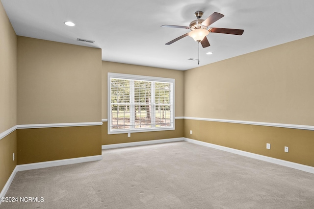 empty room with ceiling fan and light colored carpet