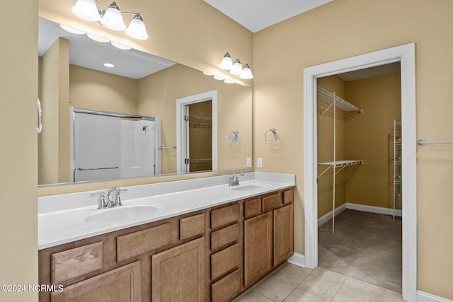 bathroom featuring tile patterned flooring, vanity, and an enclosed shower