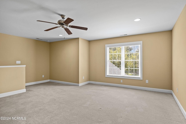 spare room with light carpet and ceiling fan