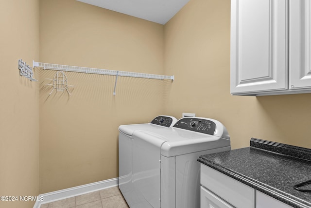 laundry room with cabinets, separate washer and dryer, and light tile patterned floors