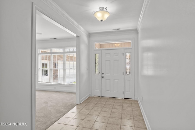 foyer featuring ornamental molding and light carpet