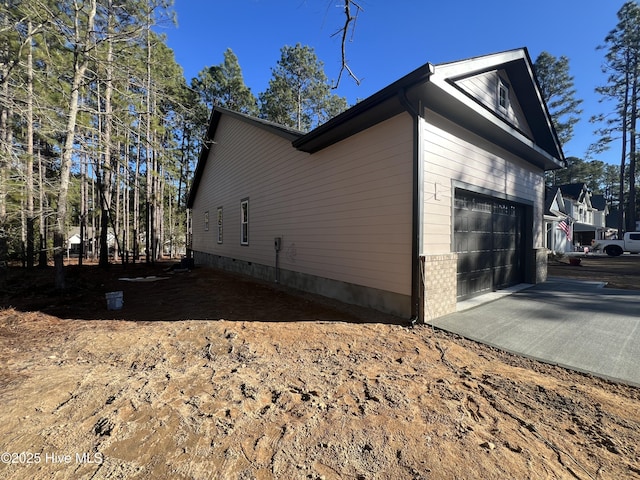 view of side of home with a garage