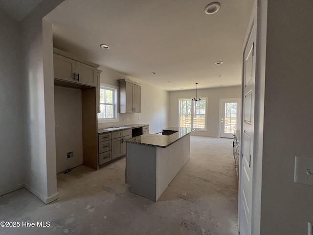 kitchen with hanging light fixtures, black dishwasher, gray cabinets, and a kitchen island